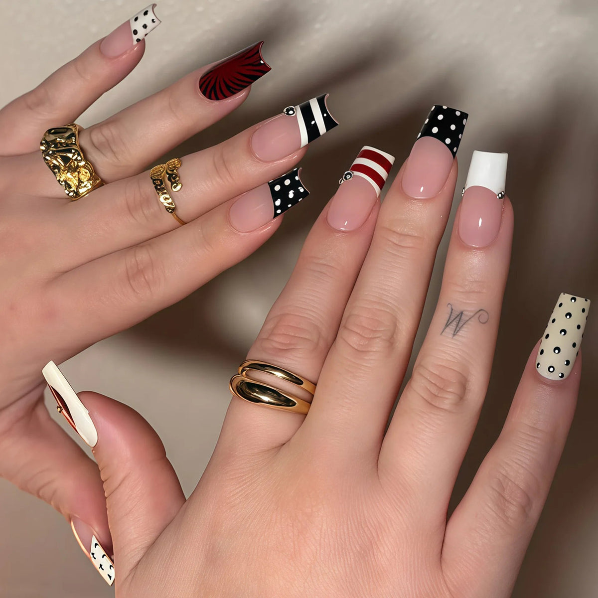 Black and White French Tip Nails with Polka Dots, Stripes, and Red Accent