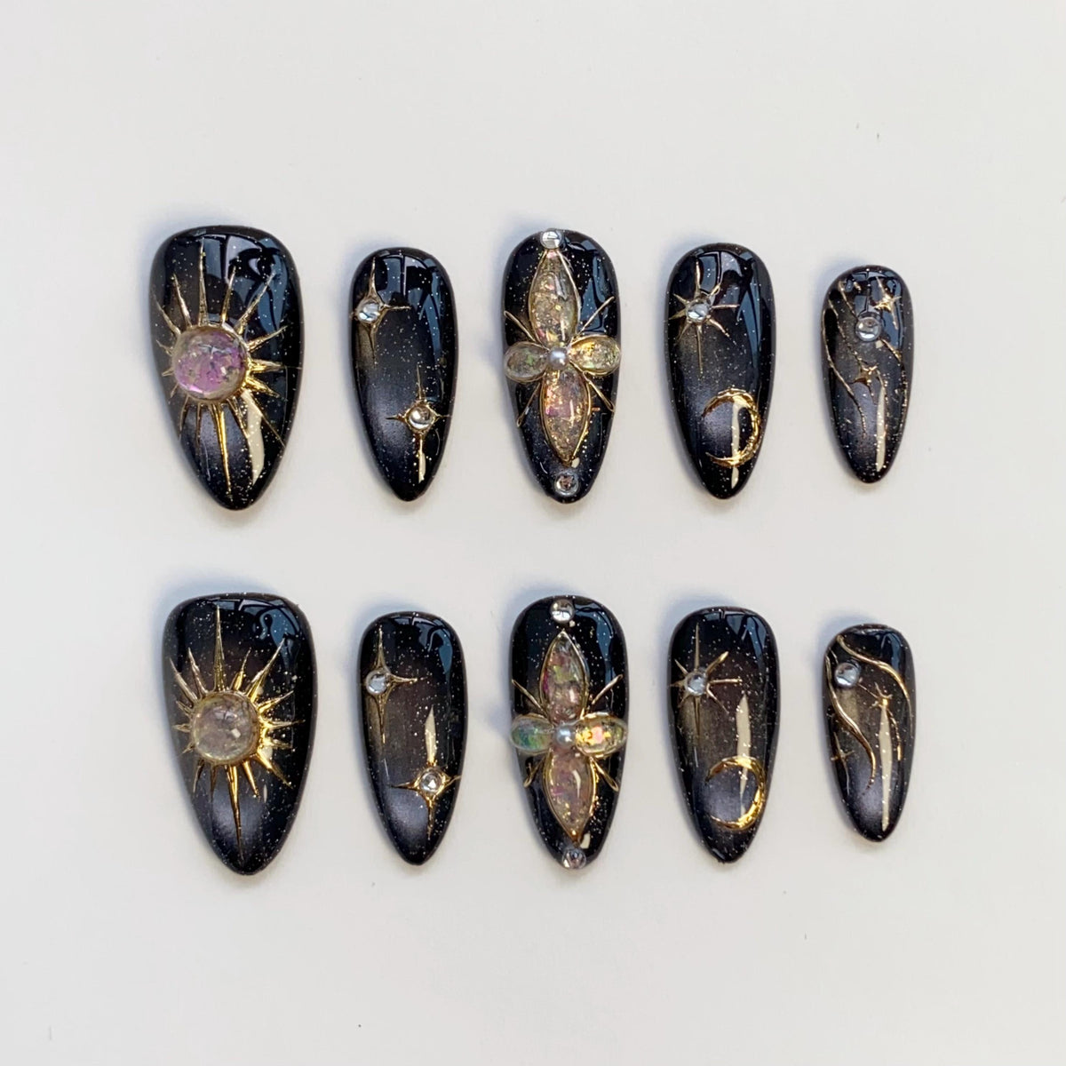 Black Cat Eye Nails With Gold Celestial Details and Gemstone Charms