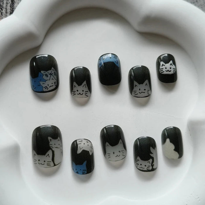 Black Cat Eye Press On Nails with White and Gray Cat Illustrations and Blue Accents