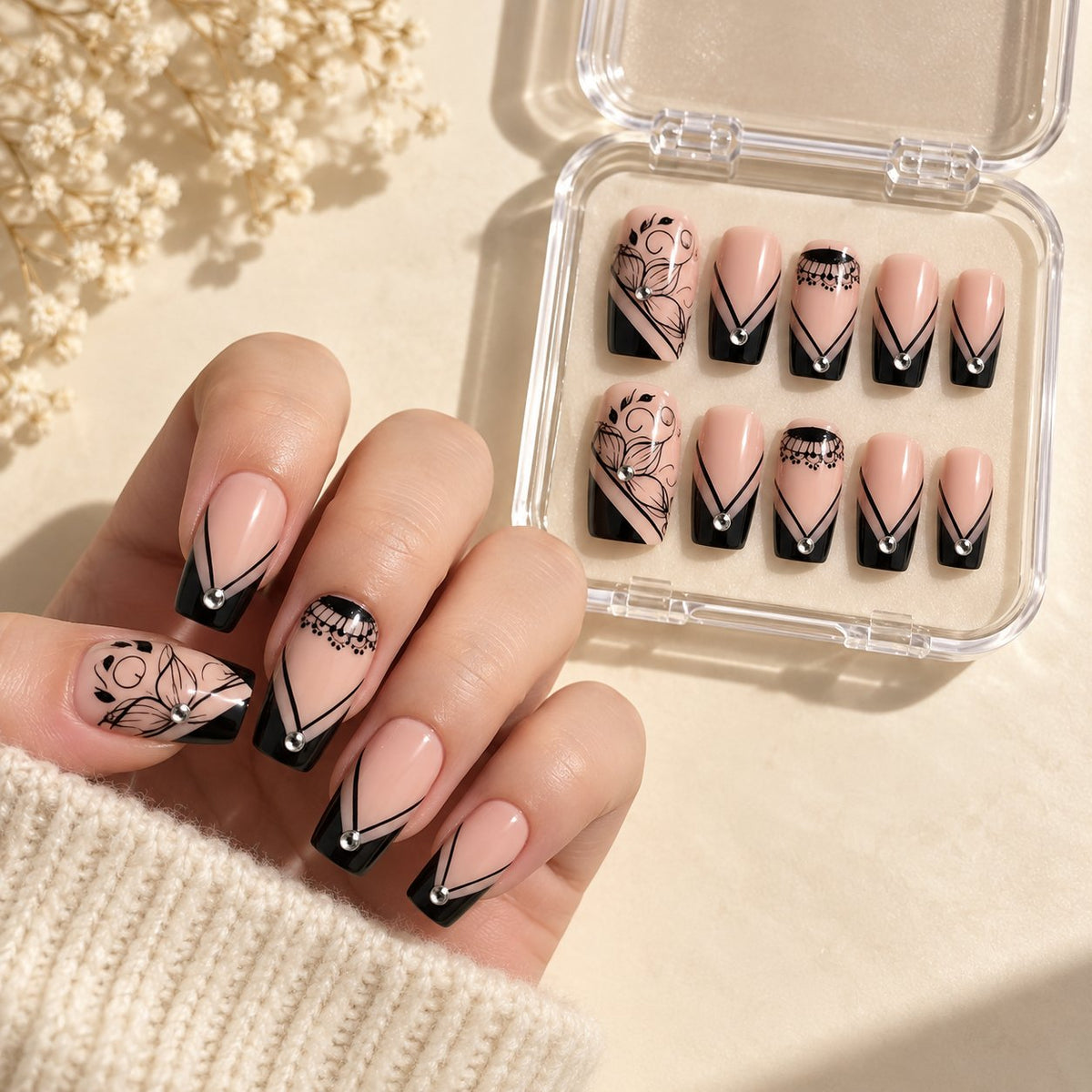 Black Lace Floral French Tip Press On Nails With Silver Rhinestones worn on hand with acrylic storage box