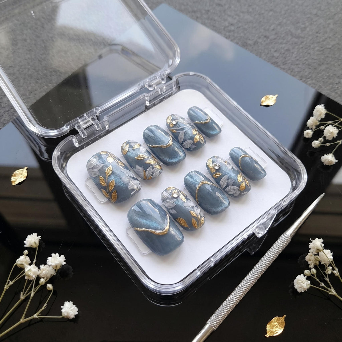Blue-Gray Cat Eye Nails With Gold Leaf and Botanical Details
