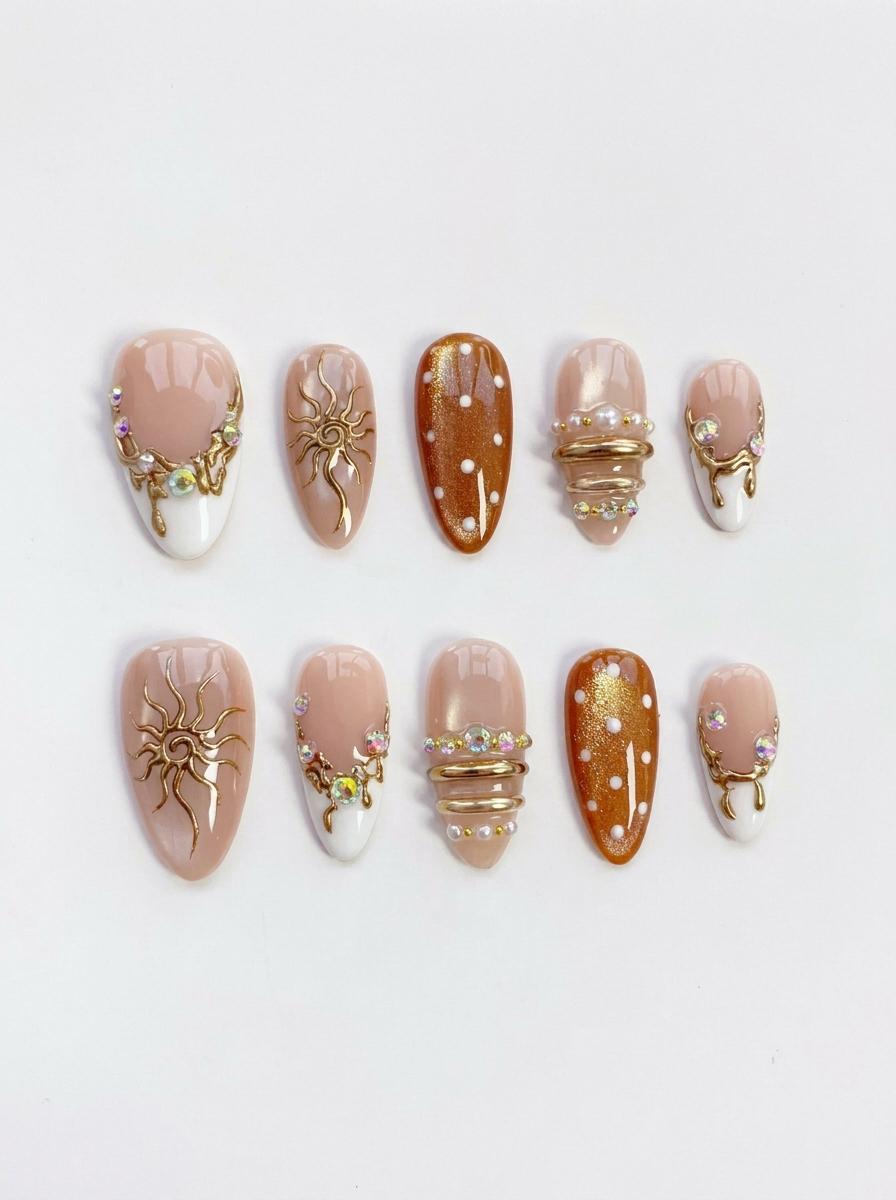 Blush French Tip Nails With Amber Dots, Gold Sun Motifs, and Rhinestones
