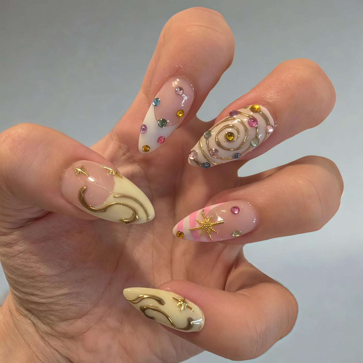 Blush Pink and Ivory Nails with Gold Swirls, Starbursts, and Colorful Gems