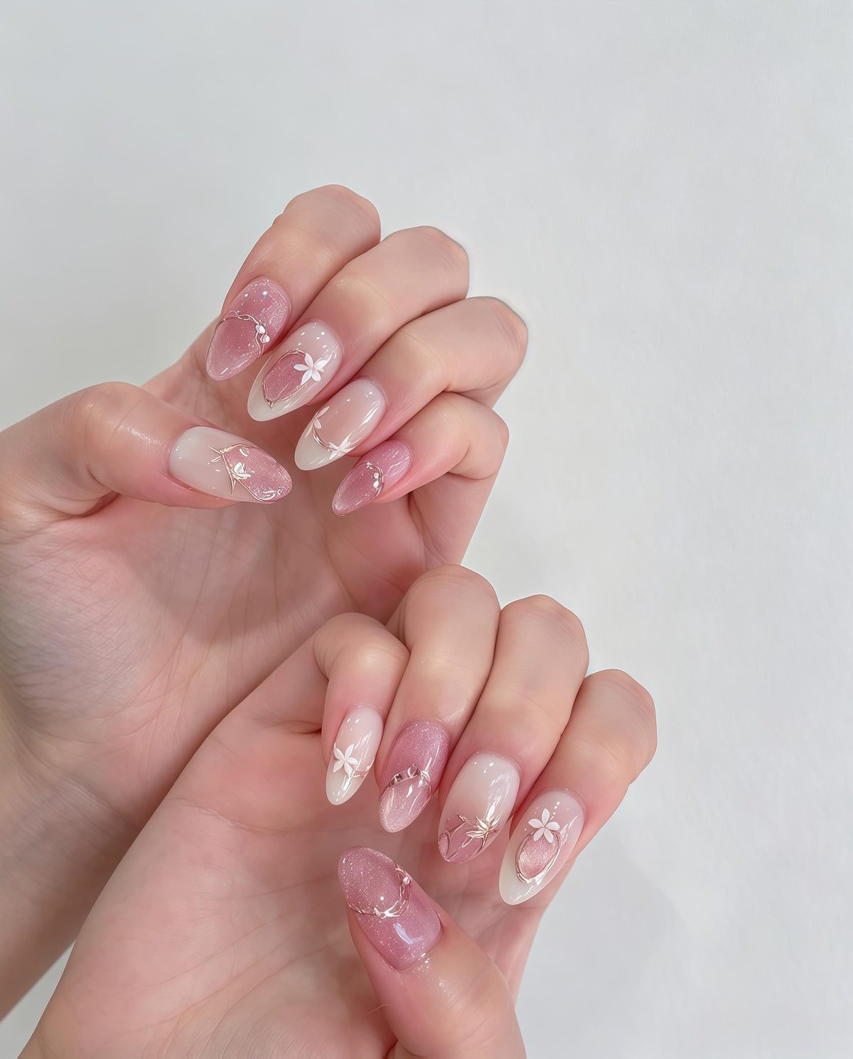 Blush Pink Cat Eye Nails With White Flowers and Gold Lines for Bridal Occasions