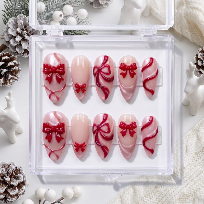 Blush Pink Christmas Press-On Nails With Raised Red Bows and Ribbon Details