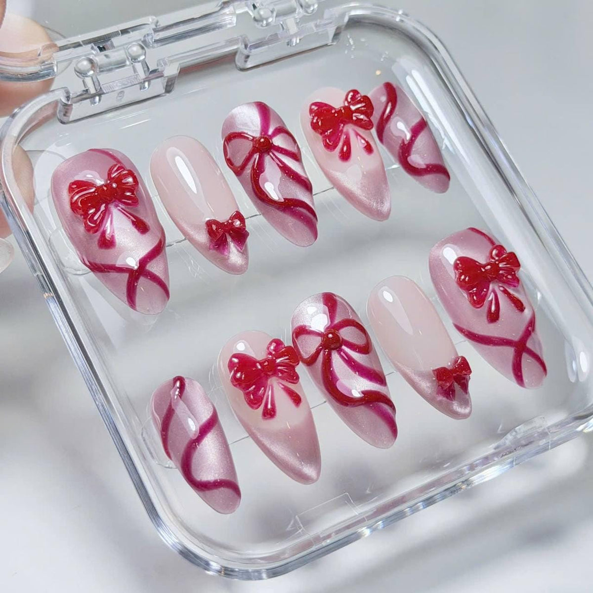 Blush Pink Christmas Press-On Nails With Raised Red Bows and Ribbon Details