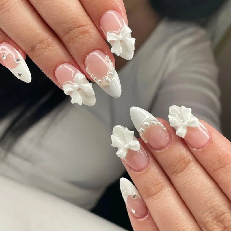 Blush Pink French Tip Nails with 3D White Bows and Pearl Accents