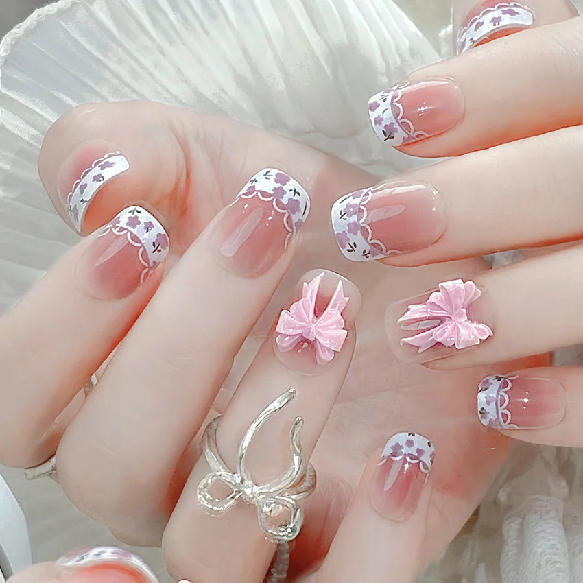 Blush Pink French Tip Nails with Floral Details and 3D Bows