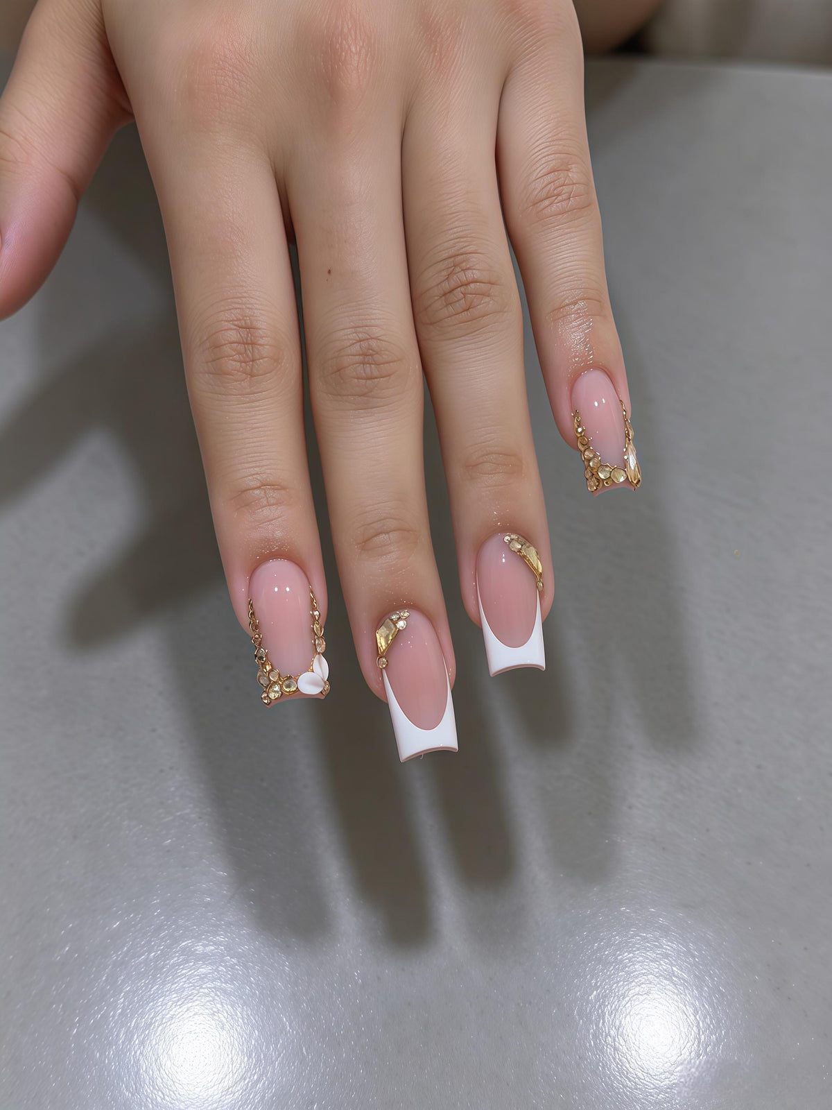 Blush Pink French Tip Nails with Gold Chains and Rhinestone Accents