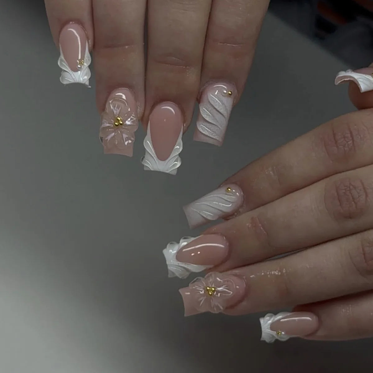 Blush Pink French Tip Nails with Translucent 3D Flowers and Gold-Toned Accents