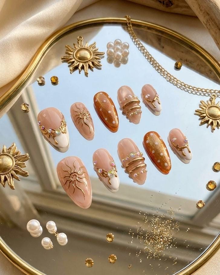 Brown Cat Eye and Blush French Tip Nails with Gold Sun Details