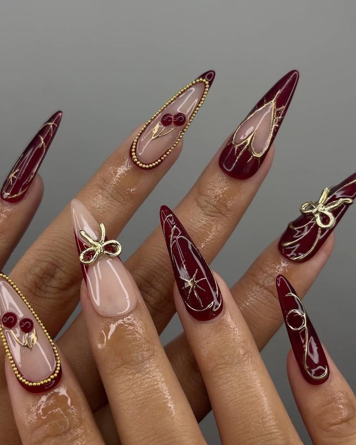 Burgundy and Blush Pink Nails with Gold Bows, Beaded Borders and Starbursts