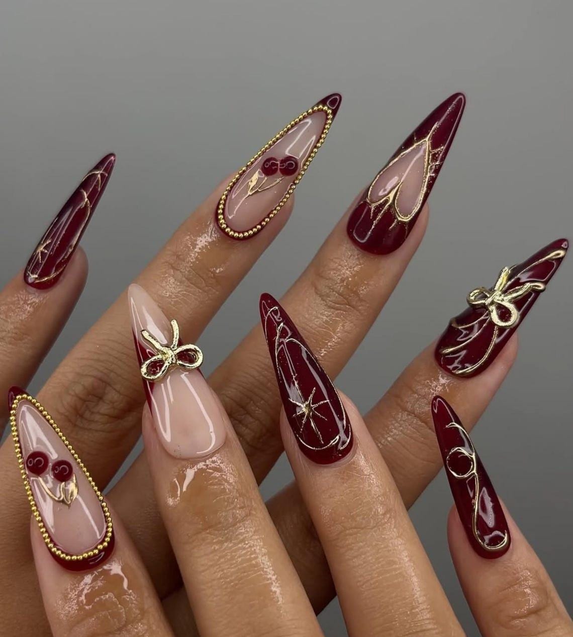 Burgundy and Blush Pink Nails with Gold Bows, Beaded Borders and Starbursts