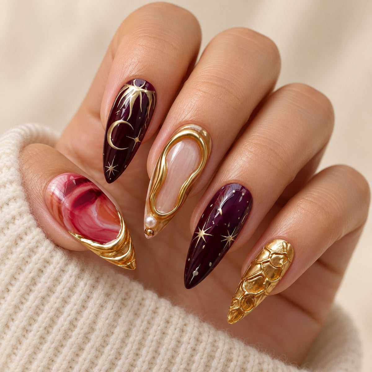 Burgundy and Gold 3D Sculptural Press-On Nails with Marble Swirls worn on hand