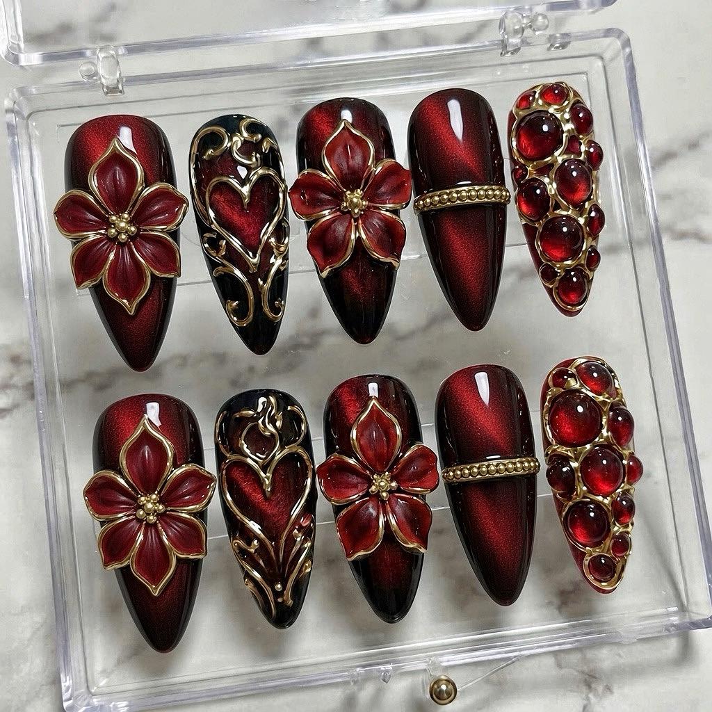 Burgundy Cat Eye Nails With Gold Baroque Filigree and Red Rhinestones