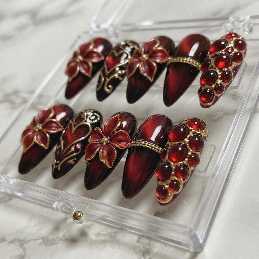 Burgundy Cat Eye Nails With Gold Baroque Filigree and Red Rhinestones