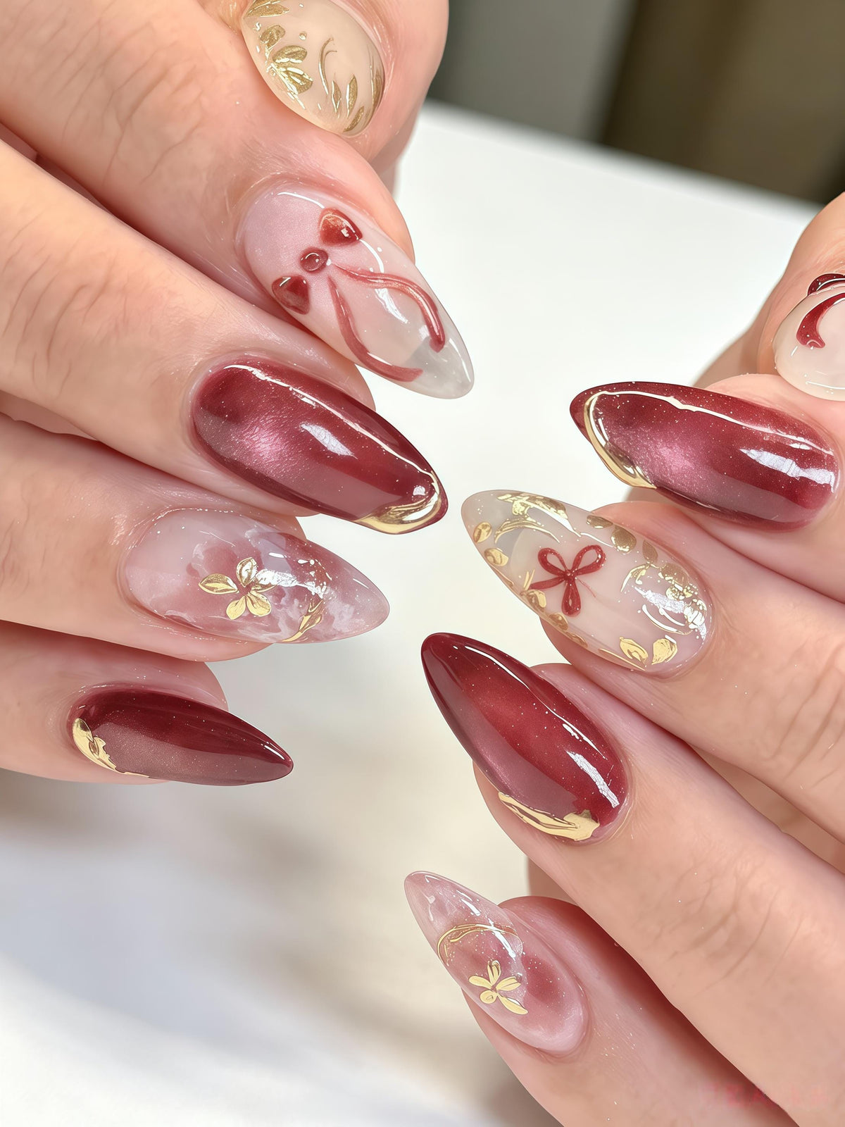 Burgundy Cat Eye Nails With Red Bows, Floral Details & Gold Foil