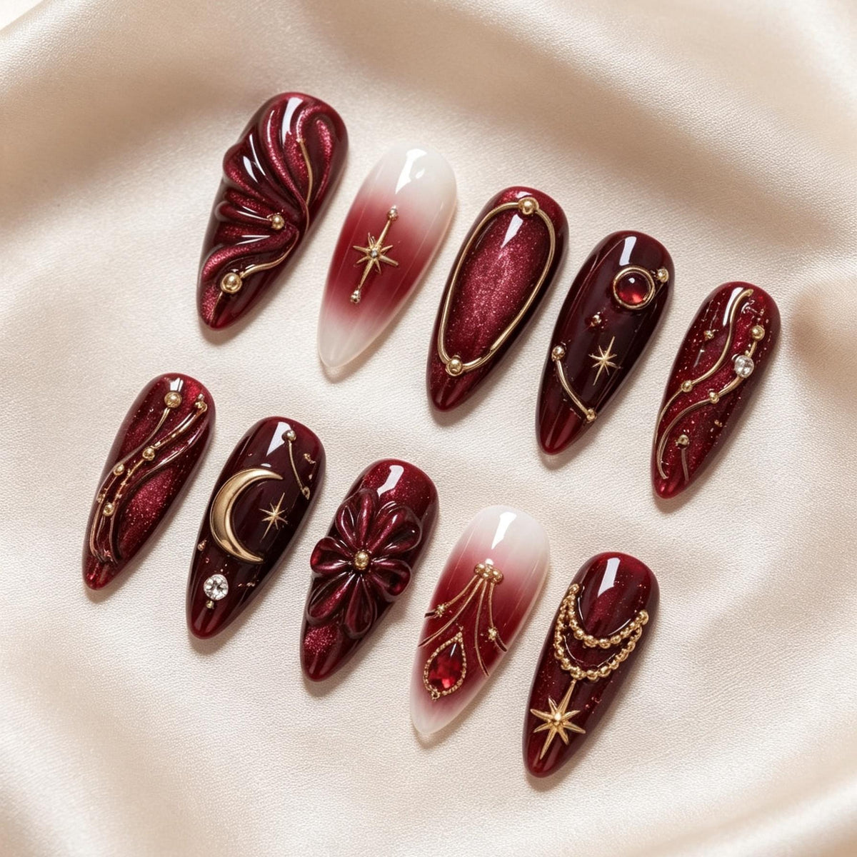 Burgundy Celestial Nail Set with Gold Moons, Starbursts, and Sculpted Flowers