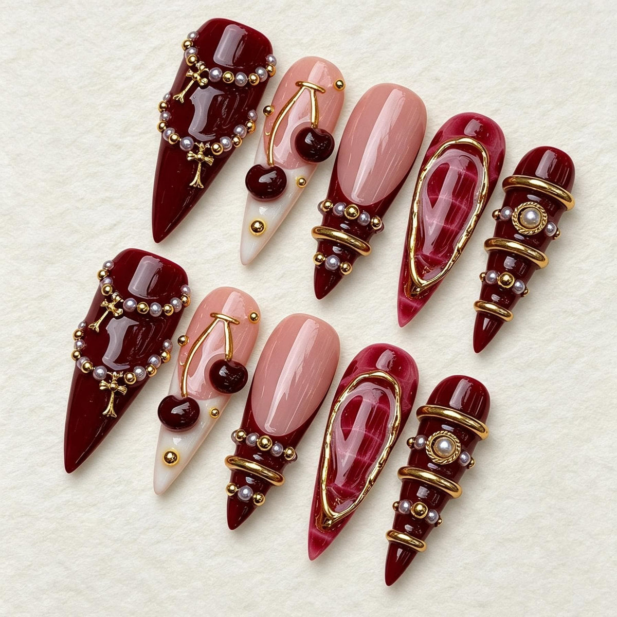 Burgundy Cherry Nails with Pearl Beads and Gold Jewelry Details