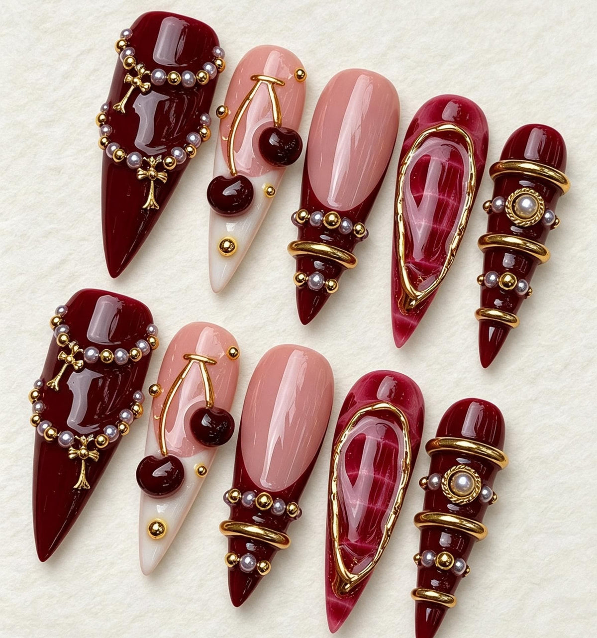 Burgundy Cherry Nails with Pearl Beads and Gold Jewelry Details