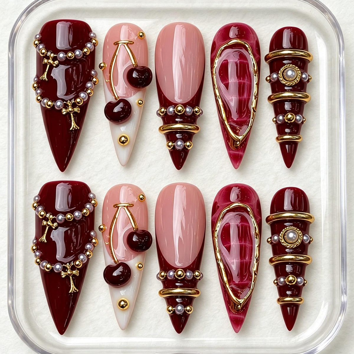 Burgundy Cherry Nails with Pearl Beads and Gold Jewelry Details