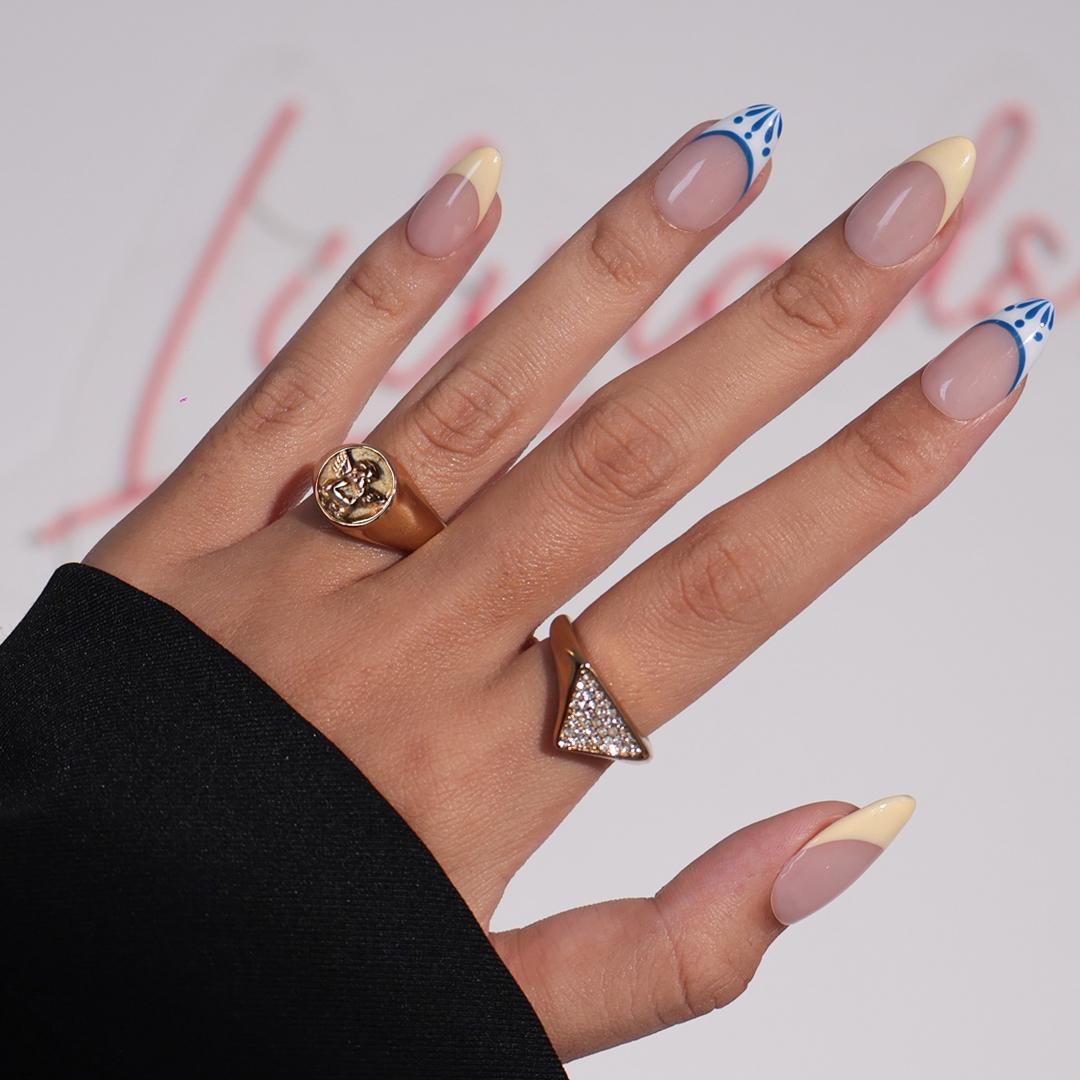 Butter Yellow French Tip Nails With Blue-Edged White Tips and Leaf Details