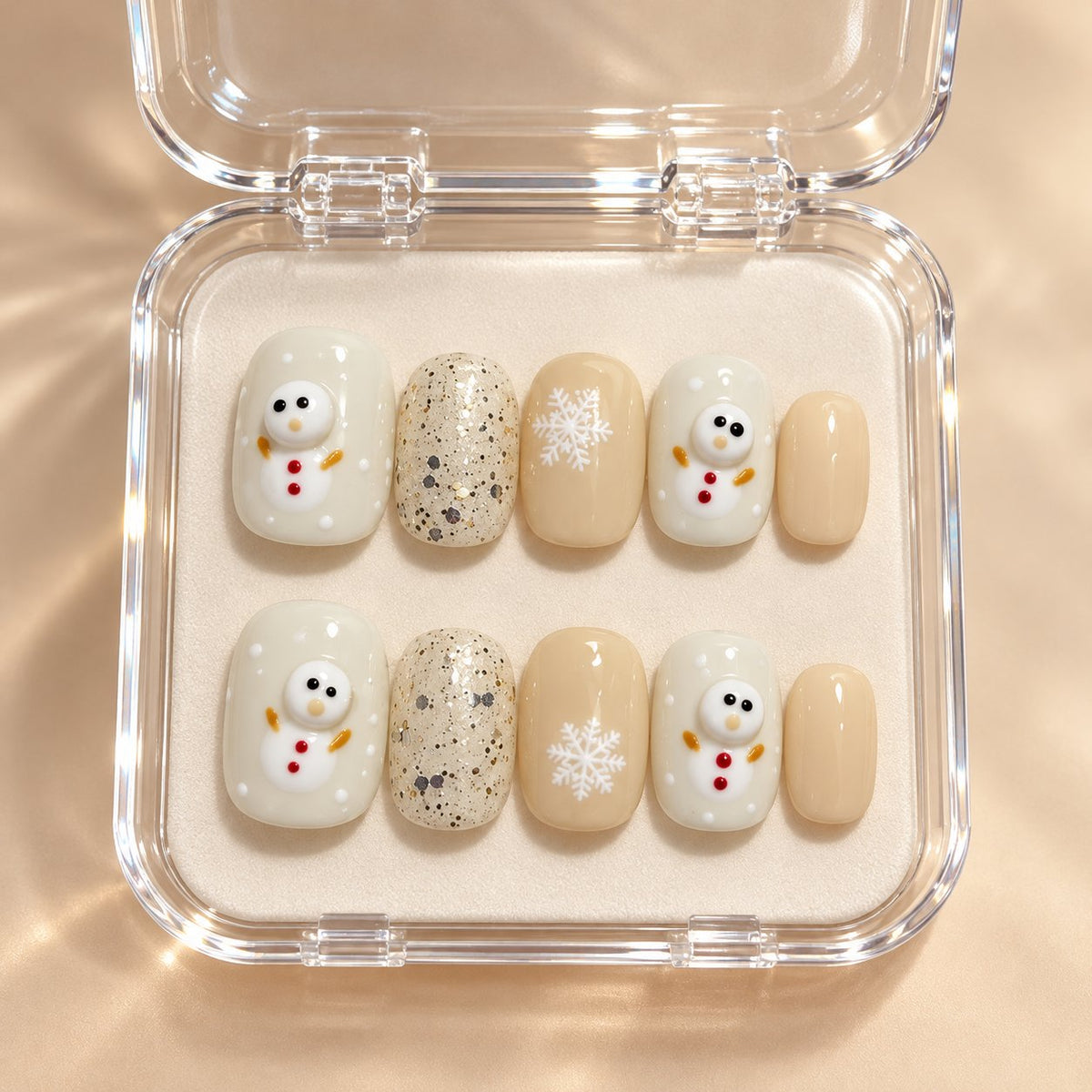Christmas Cream Snowman and Snowflake Glitter Press-On Nails in clear acrylic storage box