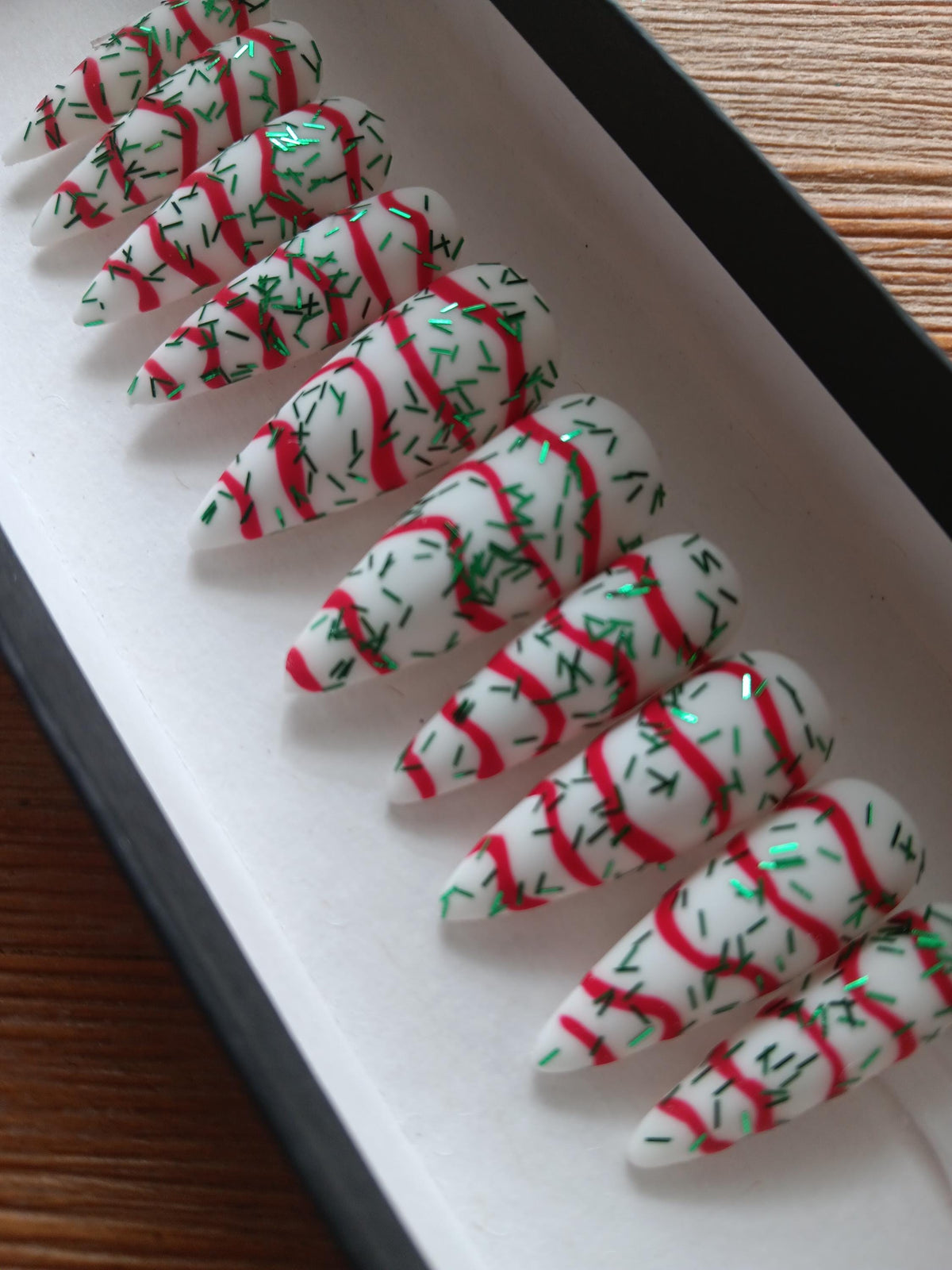 Christmas Tree Cake White Nails With Red Swirls and Green Sprigs