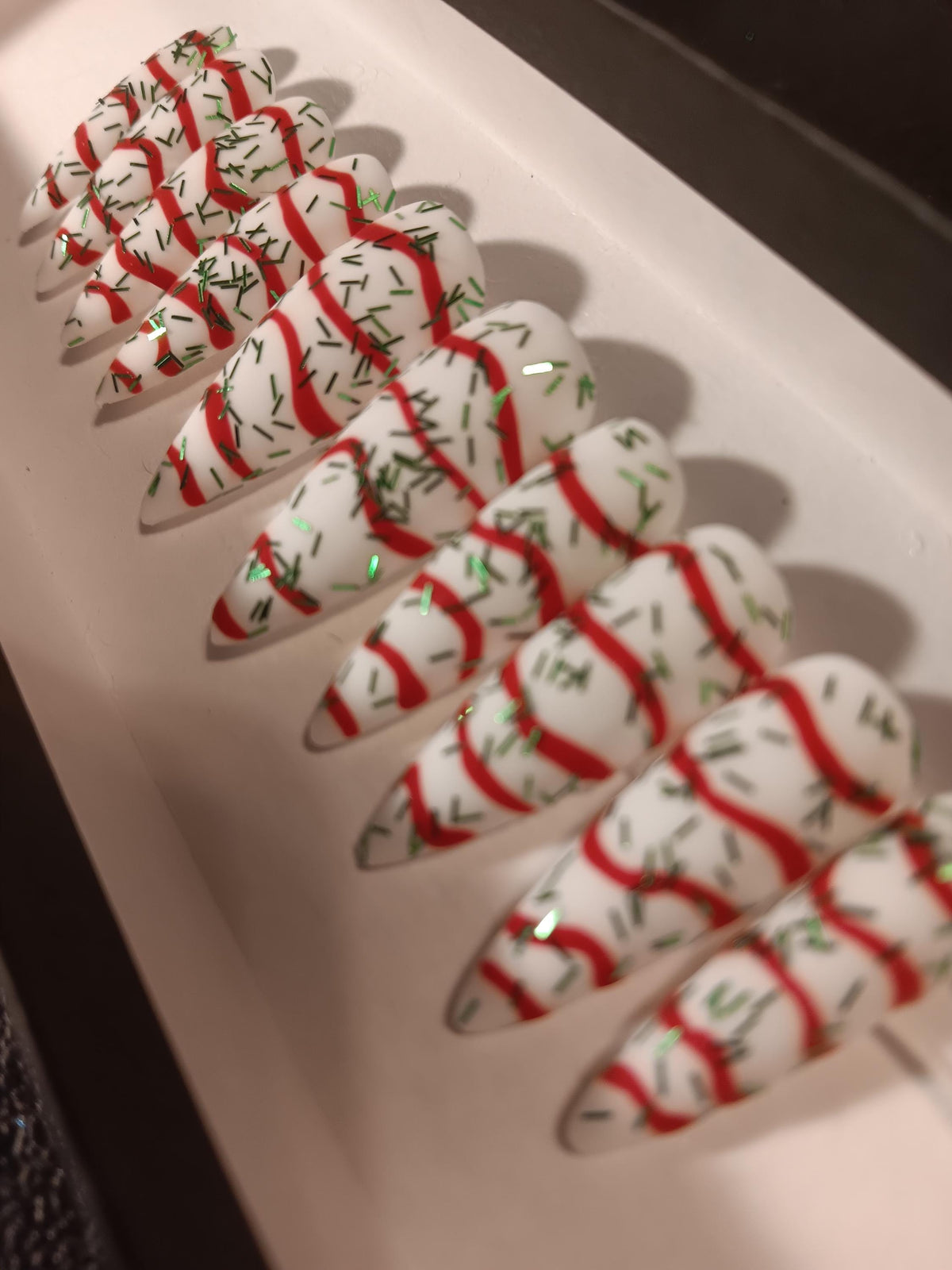Christmas Tree Cake White Nails With Red Swirls and Green Sprigs
