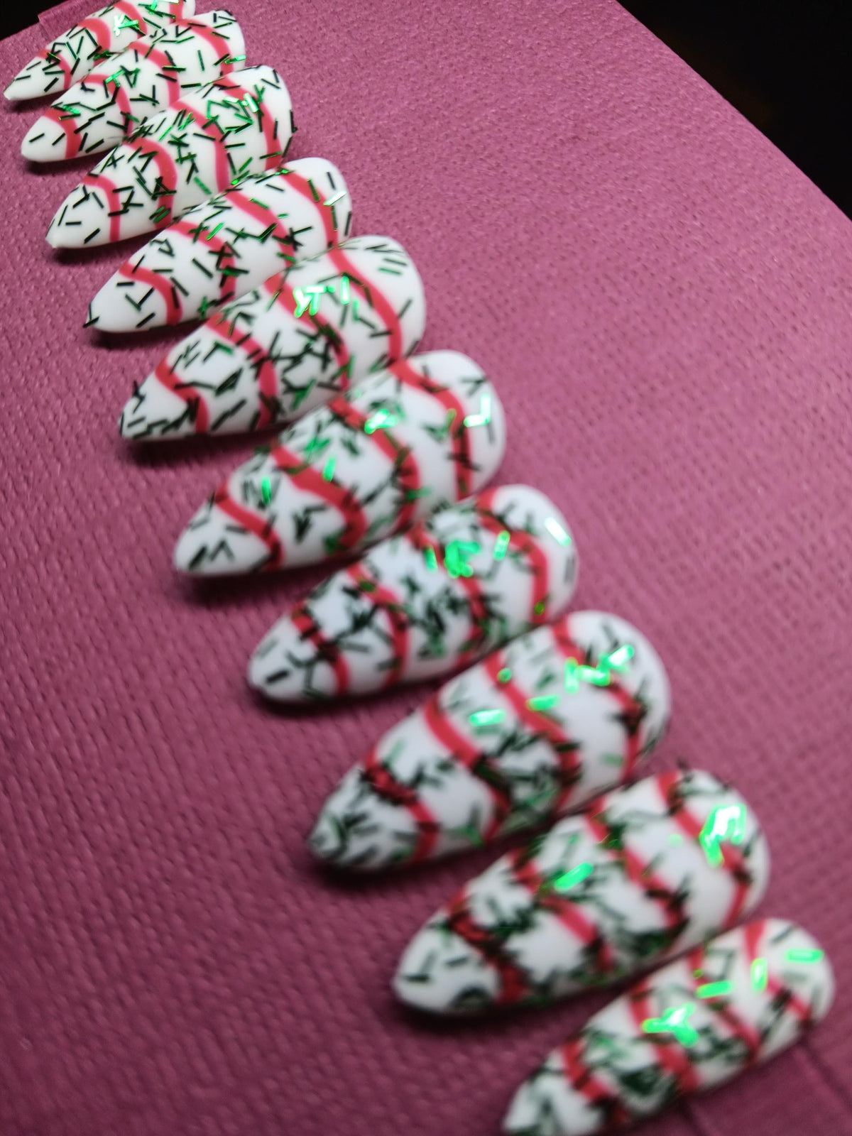 Christmas Tree Cake White Nails With Red Swirls and Green Sprigs