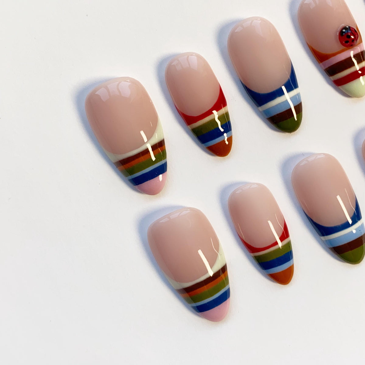Colorful Striped French Tip Nails With Ladybug Accents
