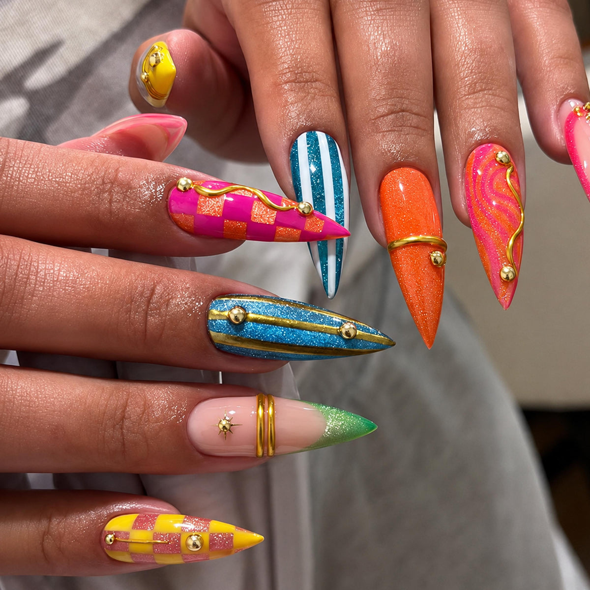 Colorful Y2K Checkerboard and Stripe Nails with Gold Accents