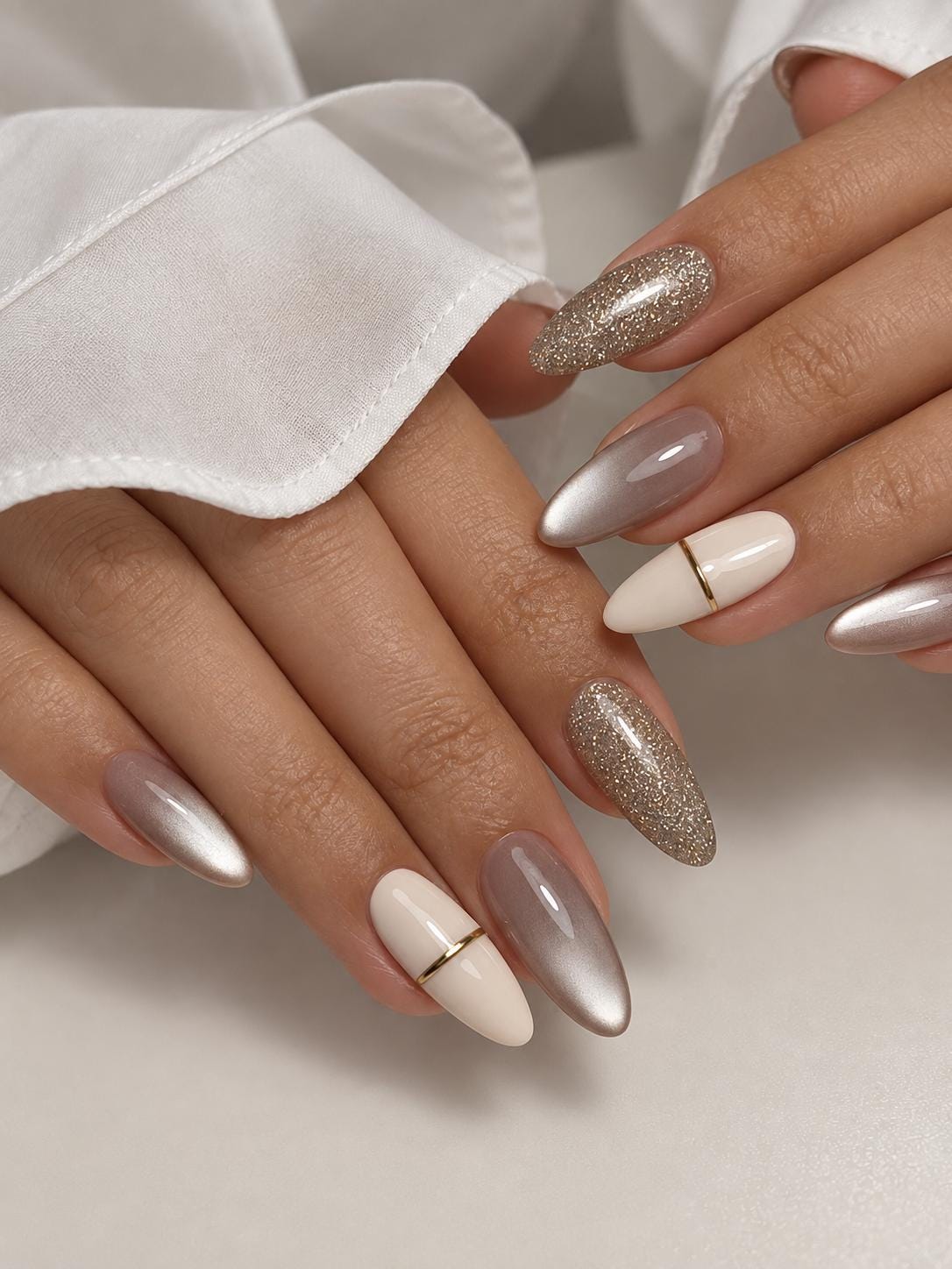 Cream and Taupe Cat-Eye Nails With Champagne-Silver Glitter and Gold Bands