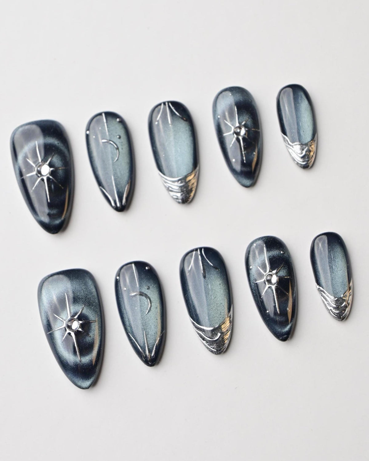 Dark Blue Cat Eye Nails with Silver Starbursts and Chrome Accents