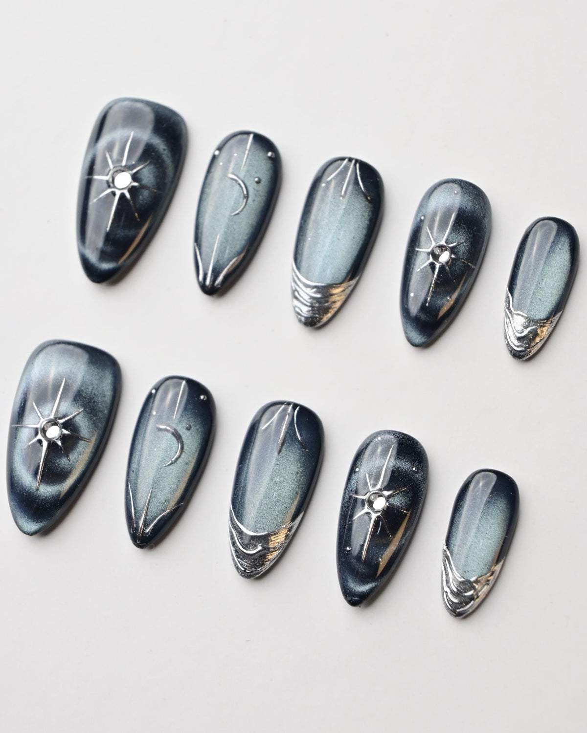 Dark Blue Cat Eye Nails with Silver Starbursts and Chrome Accents