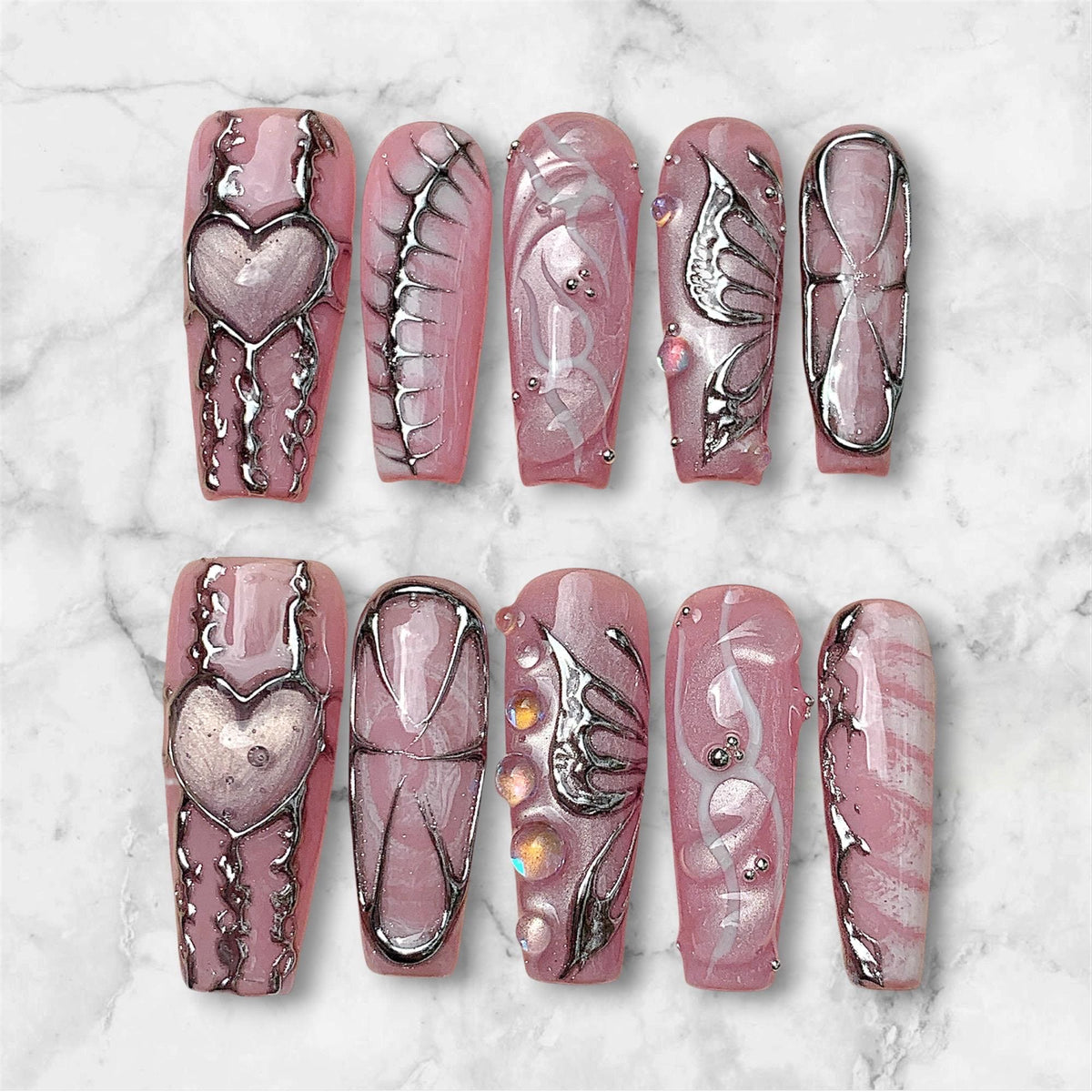 Dusty Pink Marble Press On Nails With Silver Chrome Hearts, Wings and Rhinestones