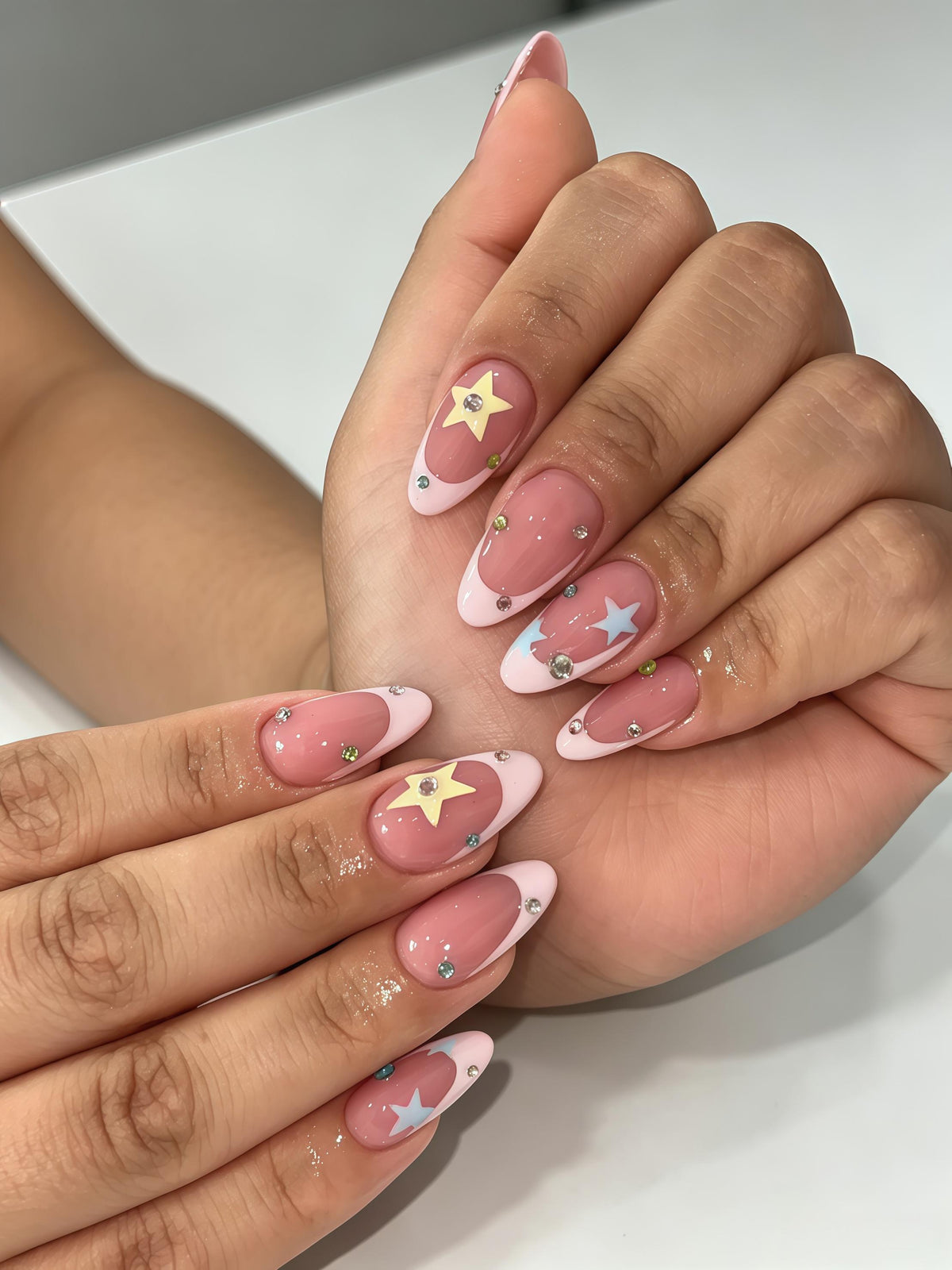 Dusty Rose French Tip Nails With Colorful Stars and Rhinestones