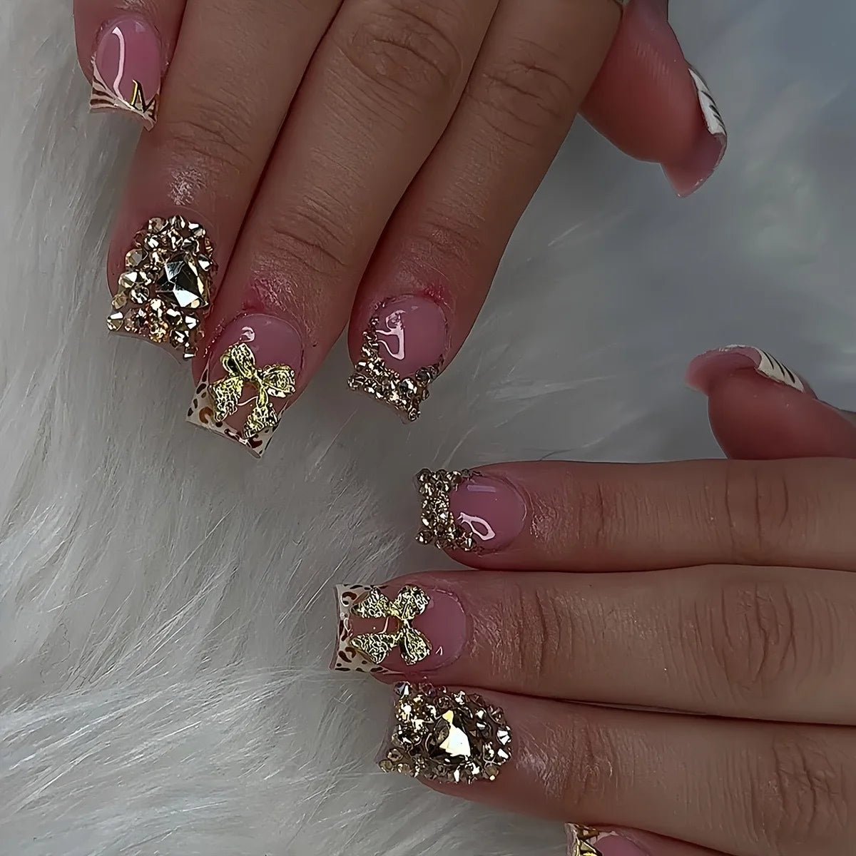 Dusty Rose French Tip Nails with Leopard Print, Gold Bows and Rhinestones