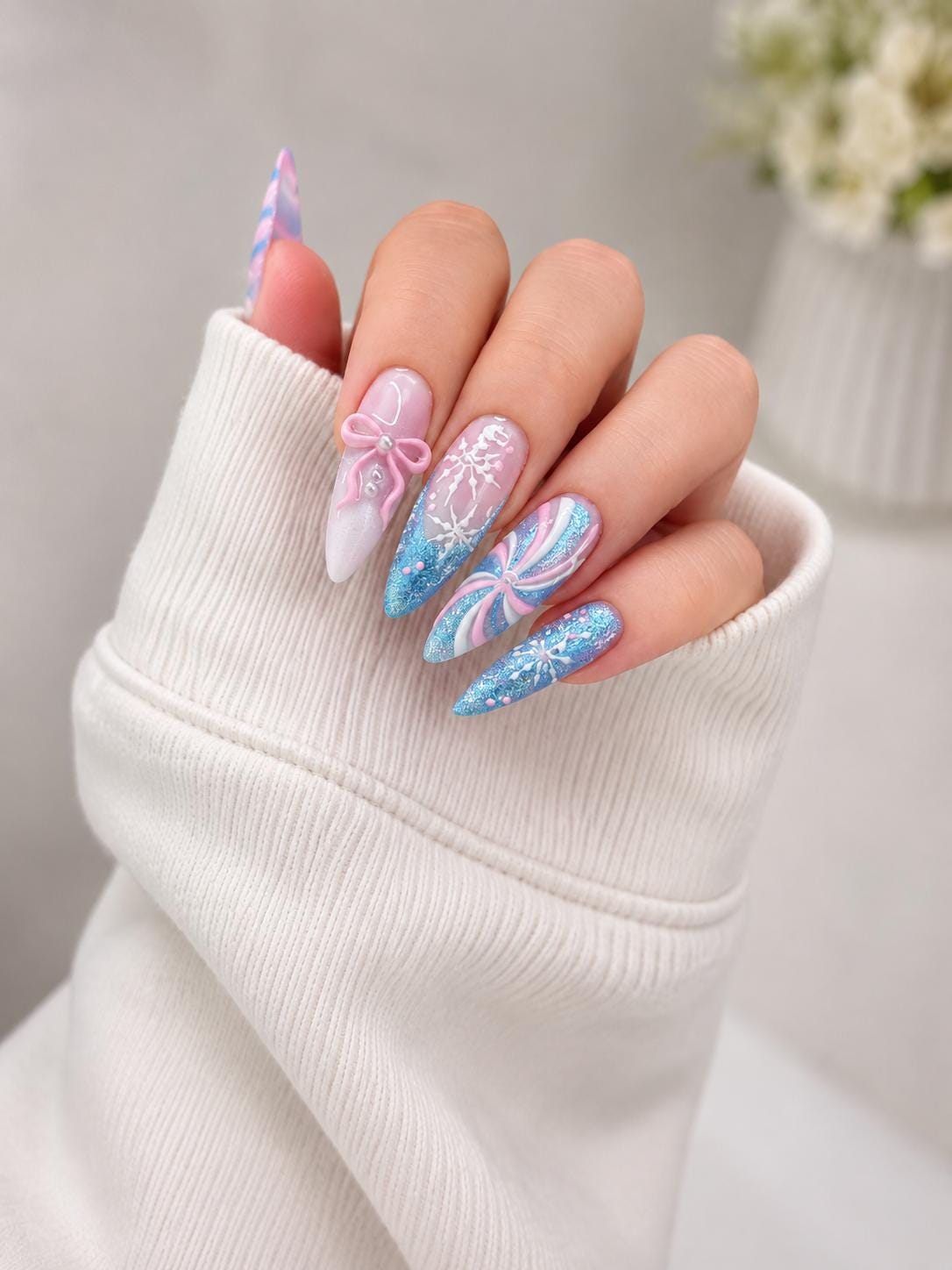 Icy Blue and Pink Winter Nails with Glitter, Snowflakes, and Pearl-Center Bows