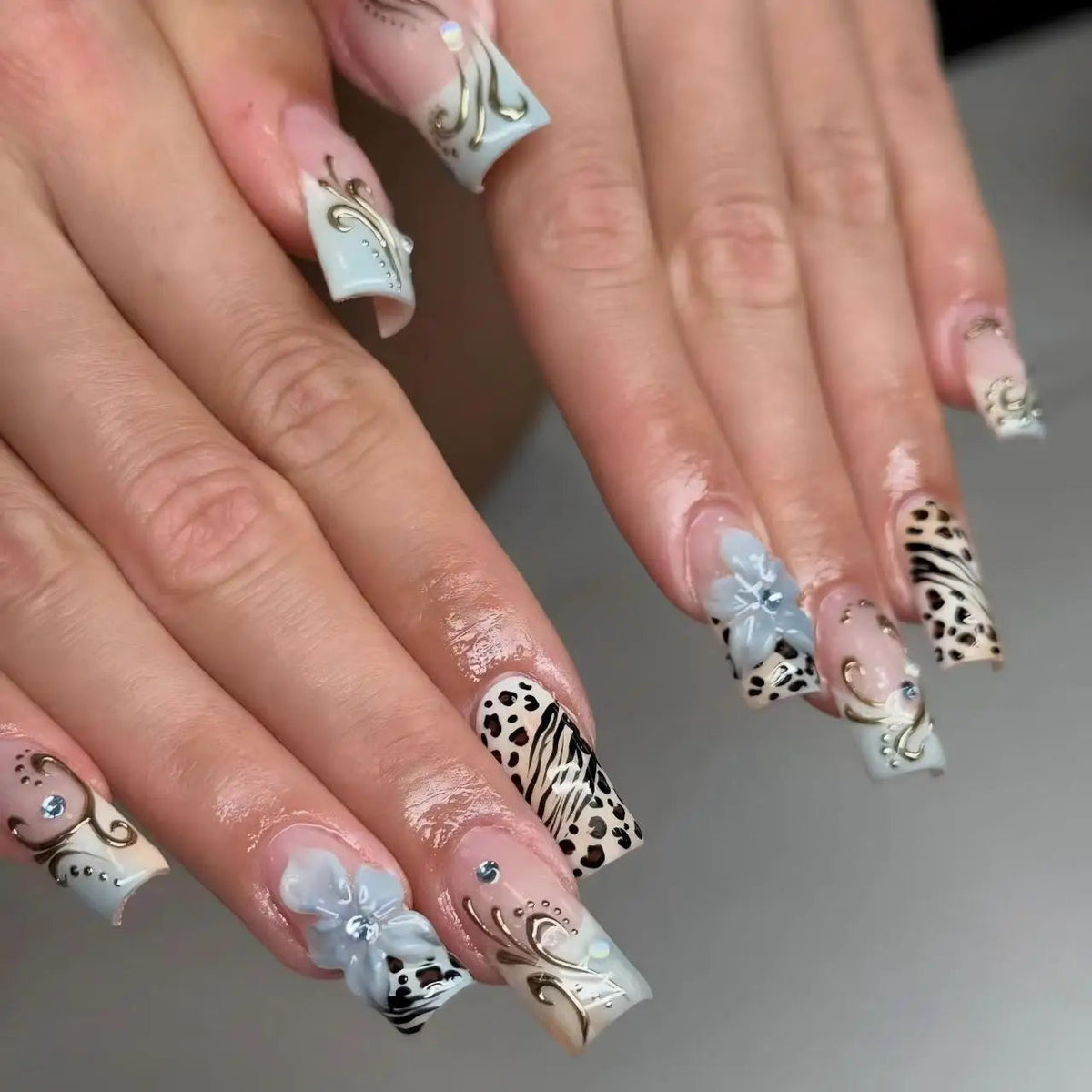 Icy Blue French Tip Nails with Animal Print, 3D Flowers and Gold Accents