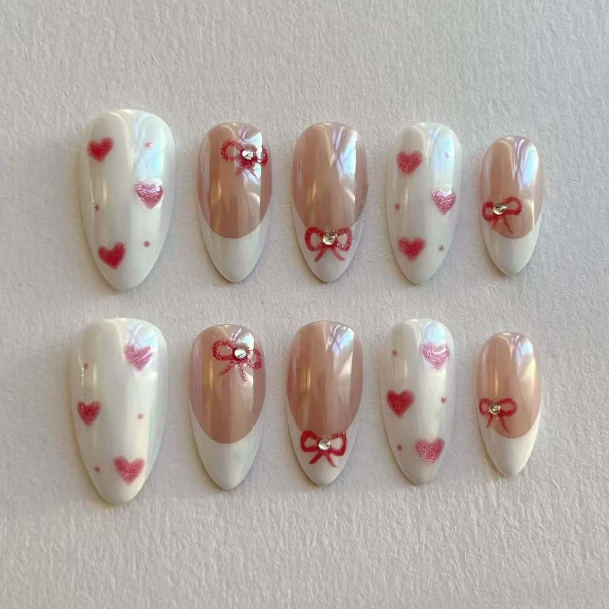 Iridescent French Tip Nails with Red Bows, Hearts, and Rhinestones