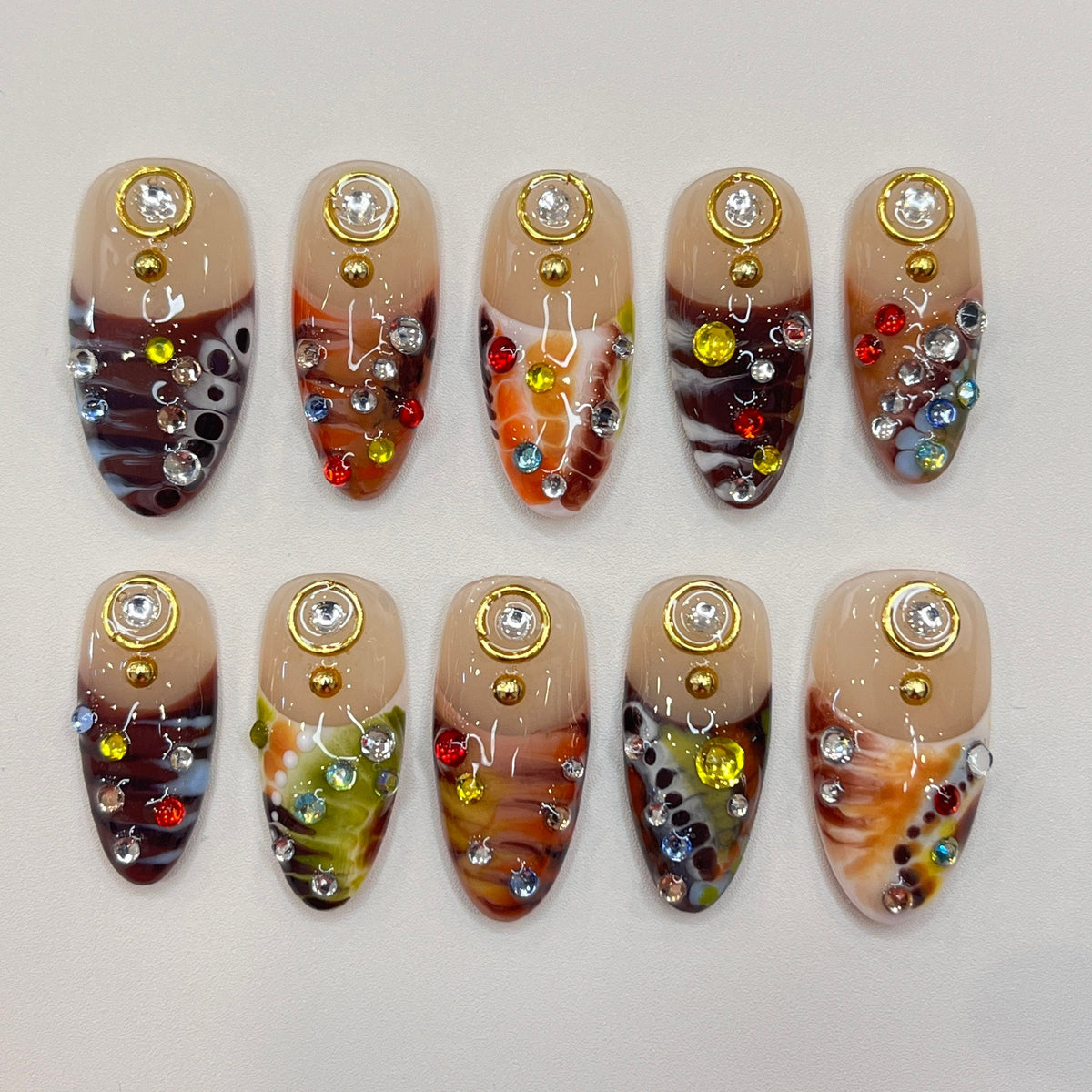 Marbled Swirl Press-On Nails with Gold-Rimmed Stones and Colorful Rhinestones