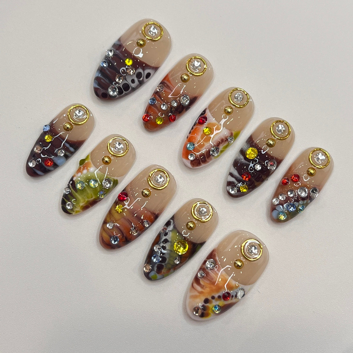 Marbled Swirl Press-On Nails with Gold-Rimmed Stones and Colorful Rhinestones