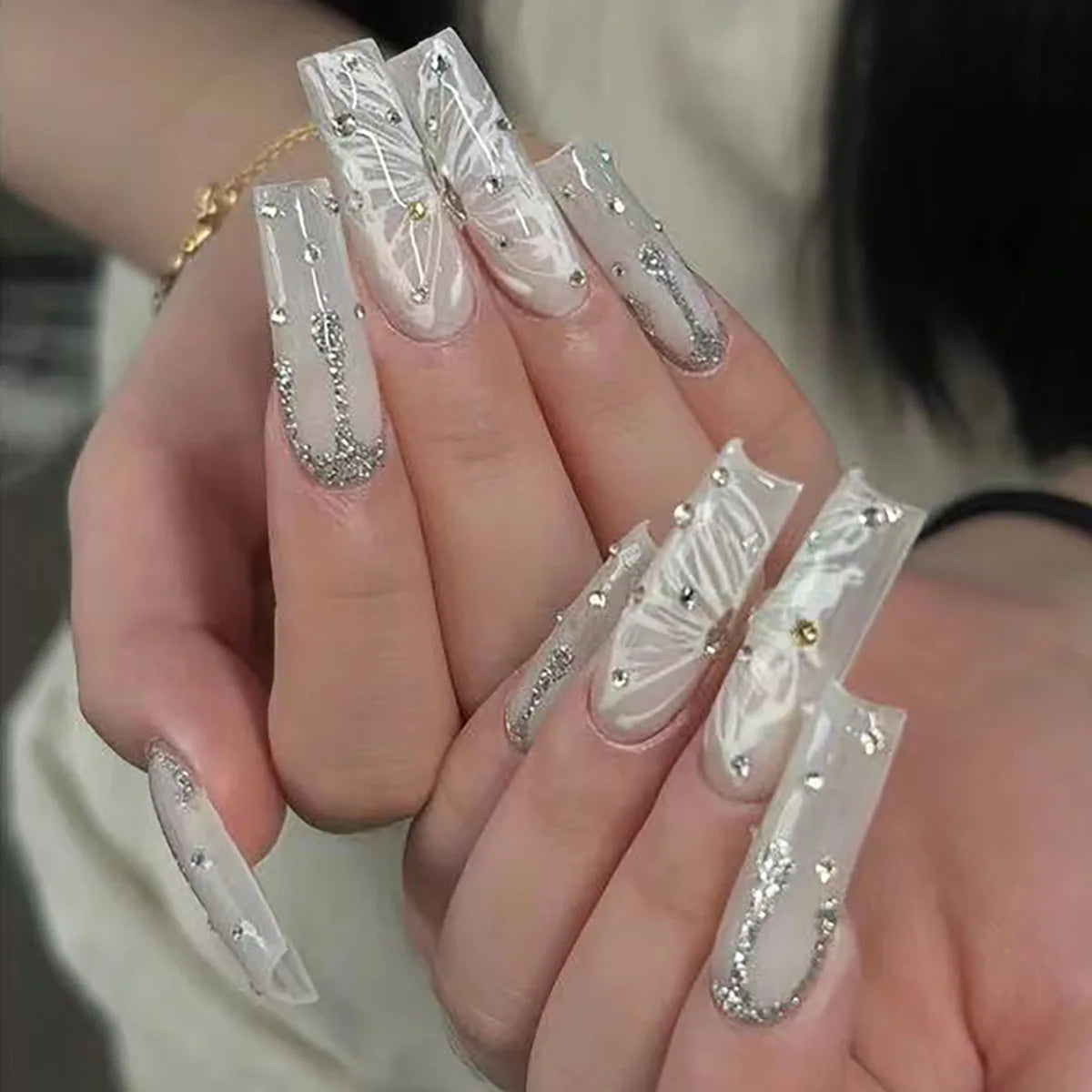 Milky White and Gray Nails with Butterfly-Wing Patterns, Silver Glitter and Rhinestones