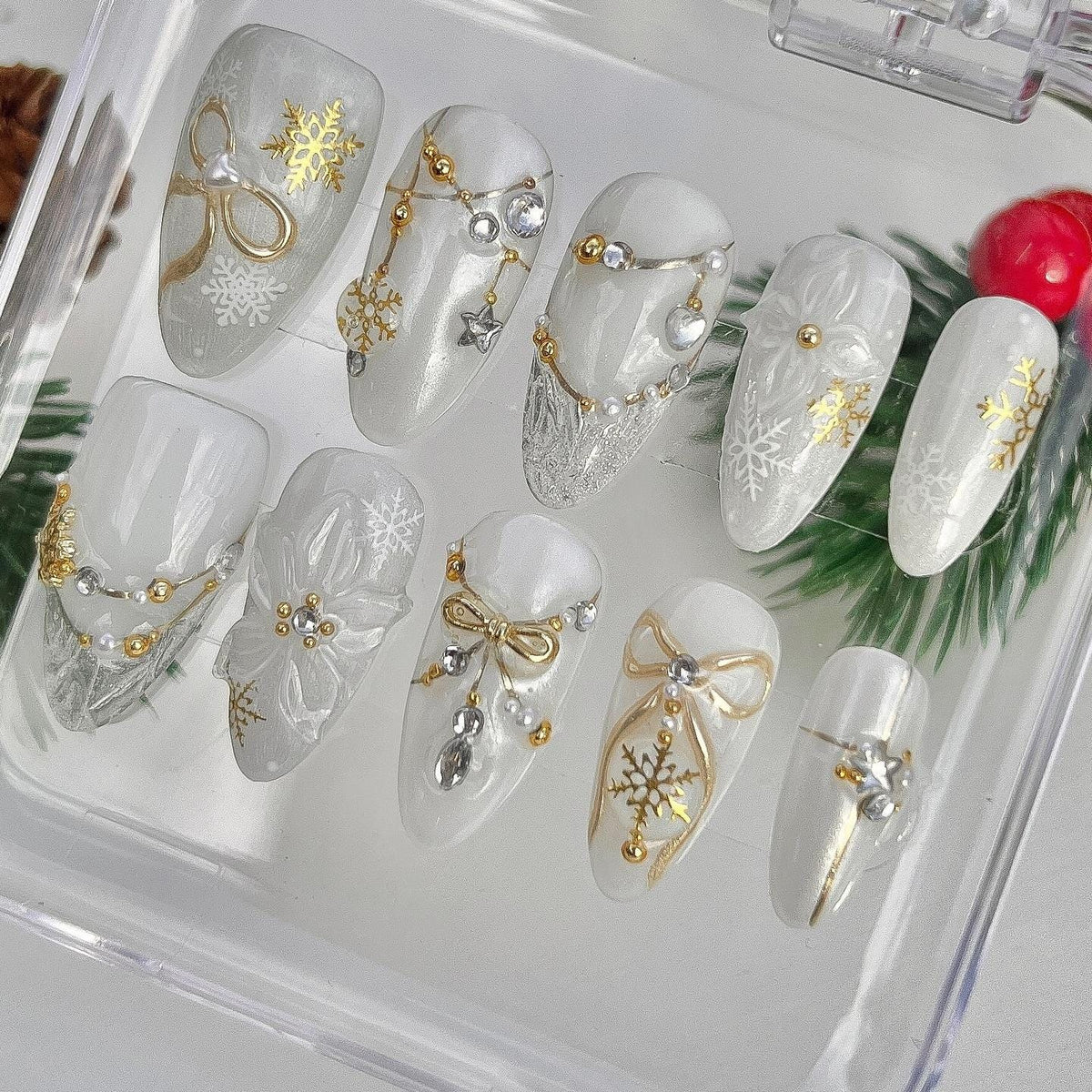 Milky White Christmas Snowflake Nails With Gold Bows, Rhinestones and Charms