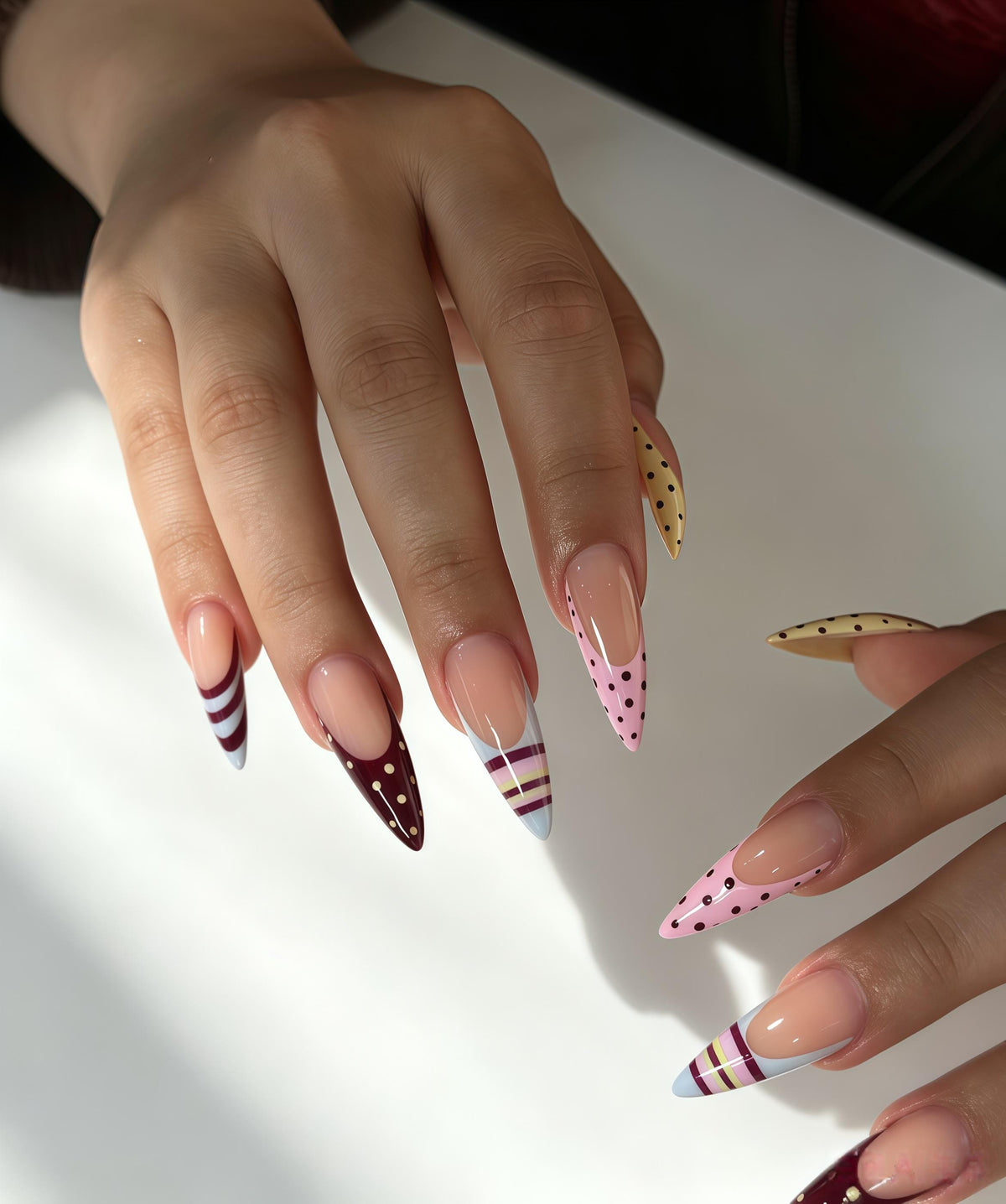 Multicolor French Tip Nails With Polka Dots, Stripes, and Curved Accents