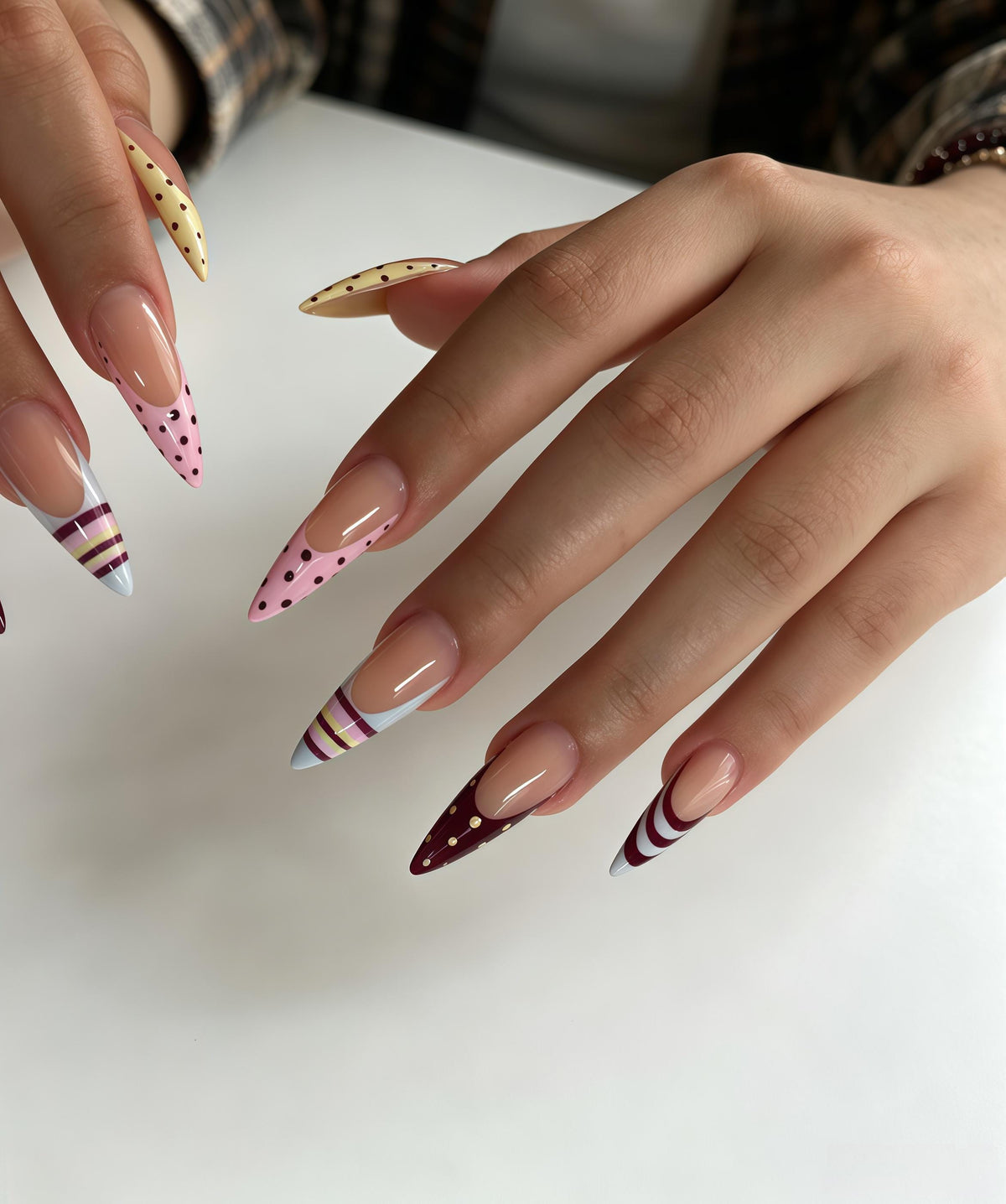 Multicolor French Tip Nails With Polka Dots, Stripes, and Curved Accents