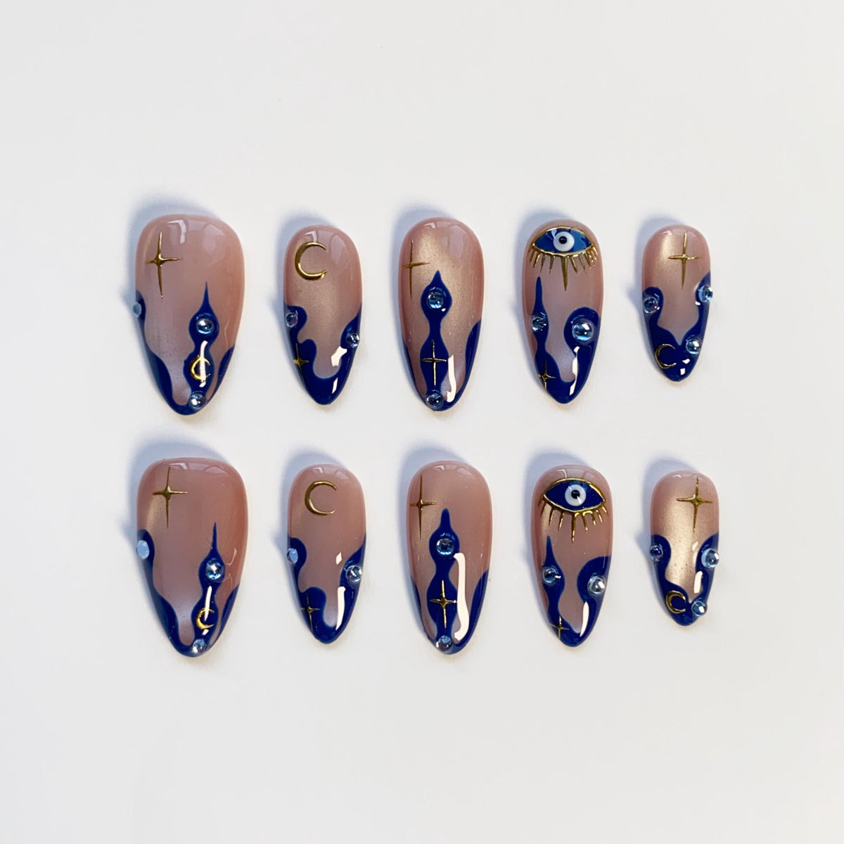 Navy Wavy-Tip Nails With Blue Evil Eyes, Gold Moons and Stars