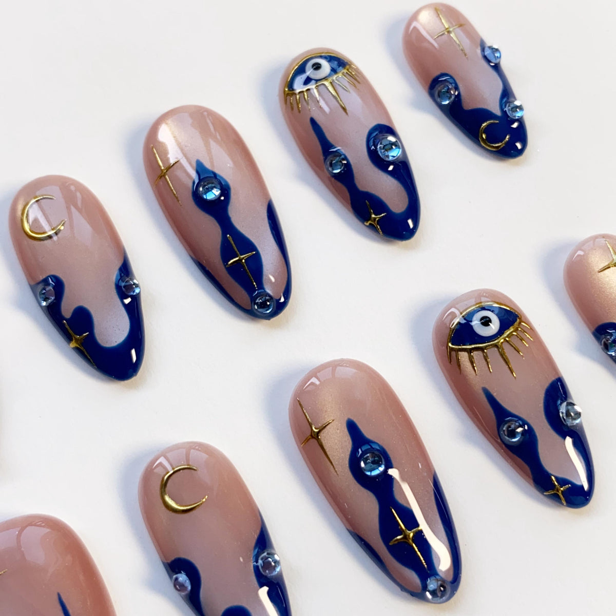 Navy Wavy-Tip Nails With Blue Evil Eyes, Gold Moons and Stars