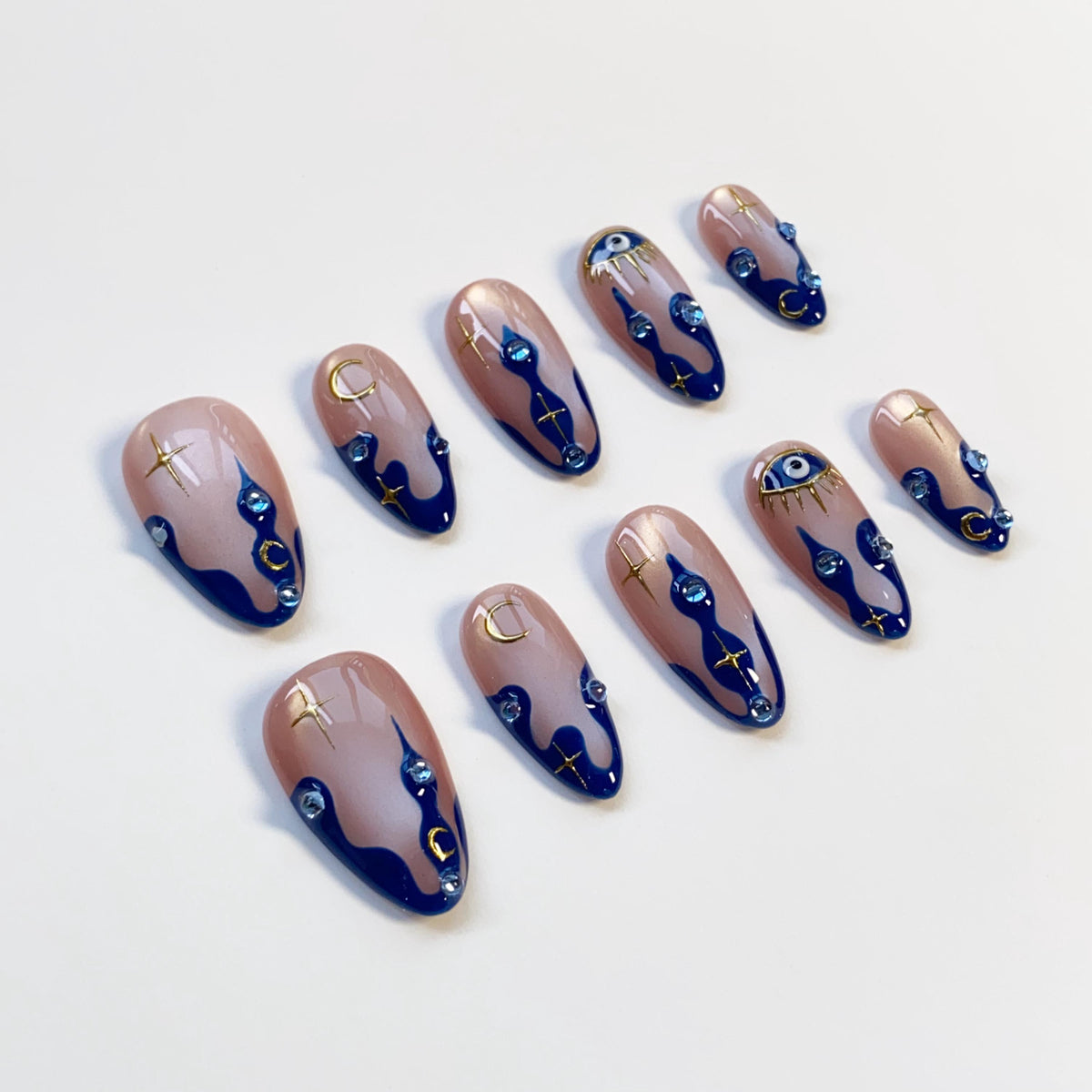 Navy Wavy-Tip Nails With Blue Evil Eyes, Gold Moons and Stars
